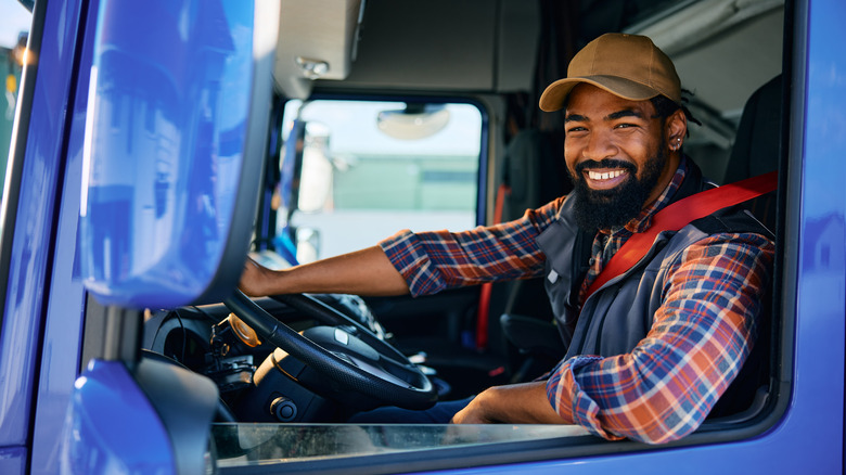 Man looking out of the window of semi-truck