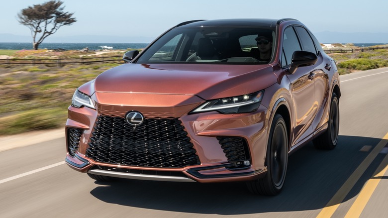 A copper 2025 Lexus RX 500h F Sport Performance on the road