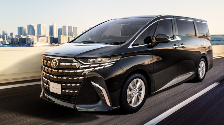 A black Toyota Alphard on the road