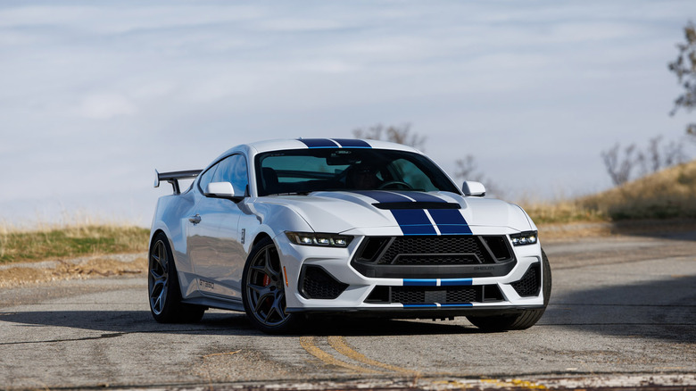 A blue and white Shelby American GT350 parked on a road