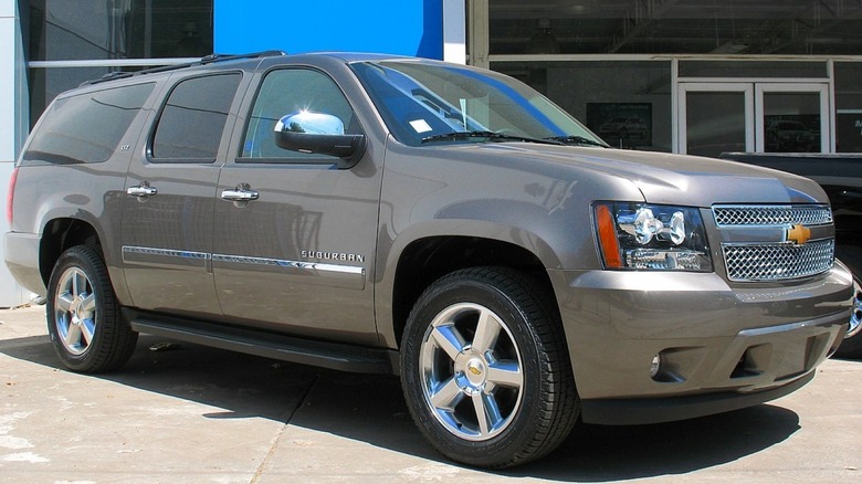 A silver 2012 Chevrolet Suburban parked