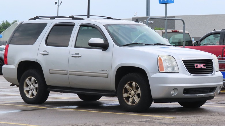 A silver 2010-2014 GMC Yukon in a parking lot