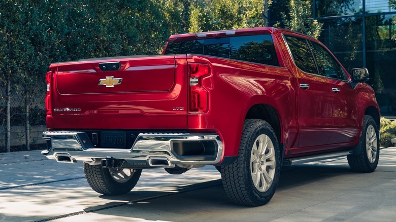The rear view of a red 2025 Chevrolet Silverado pickup truck.