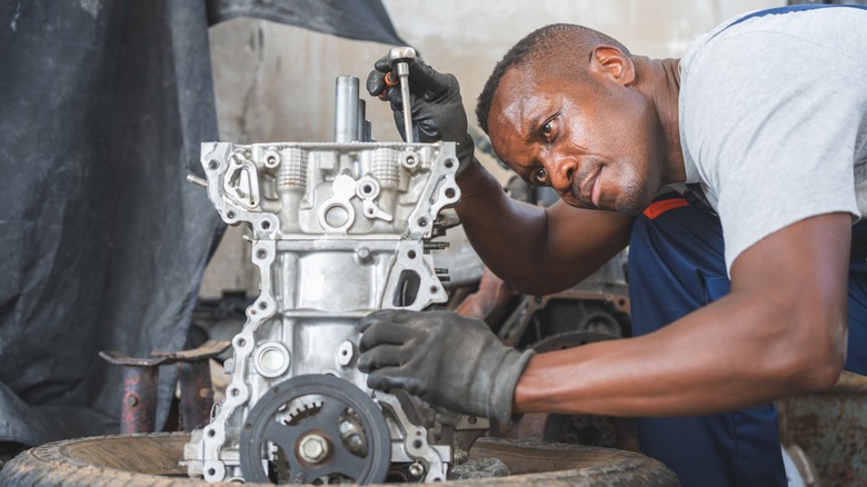 A mechanic working on an engine