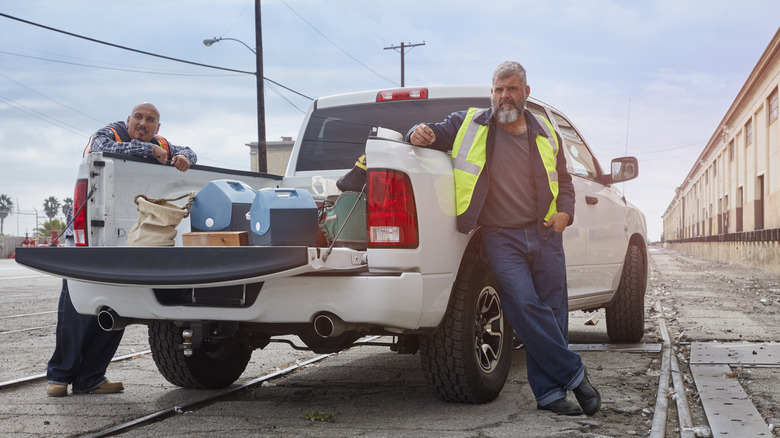 a white gmc truck with an open tailgate