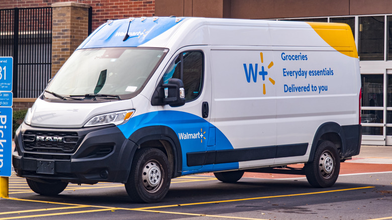 A Walmart+ delivery van sitting outside a Walmart store