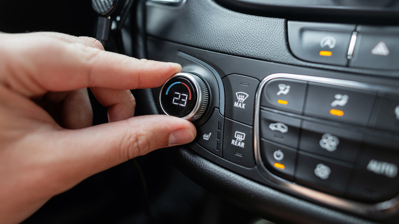 Man turns air conditioning controls