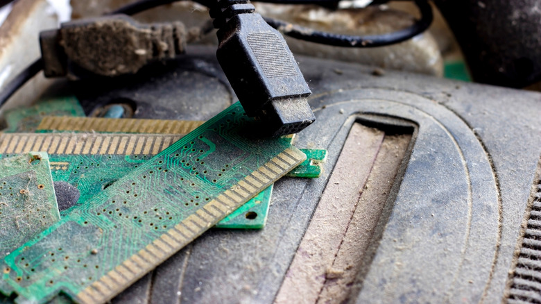 Retro game console covered vith dirt and dust.