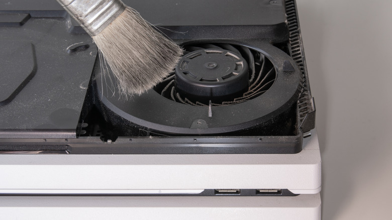 A gaming console been cleaned with a brush