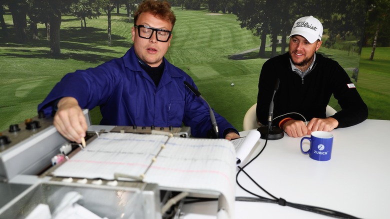 Person going through a lie detector test with a polygraph in the foreground