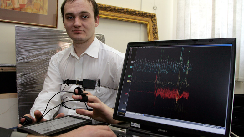 Person going through a polygraph test with a monitor in the foreground