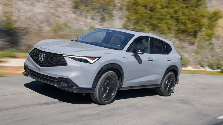 A gray Acura ADX driving on a canyon road