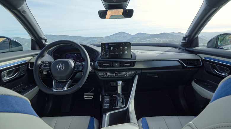 White and blue Acura ADX interior with mountains in the distance.