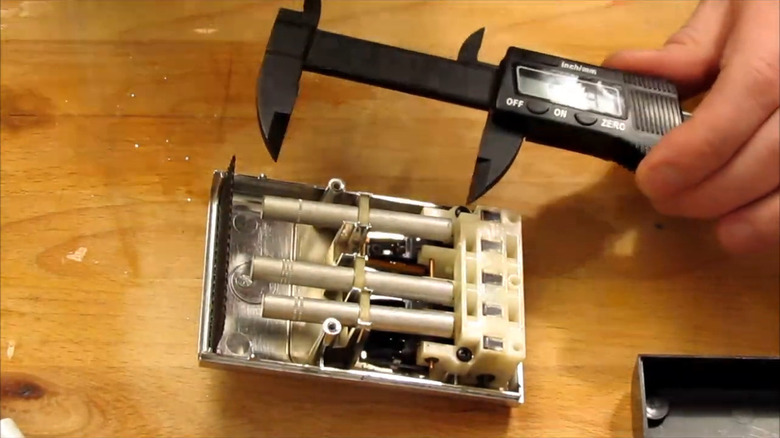 The inside of a Zenith Space Command TV remote control showing the strike rods.