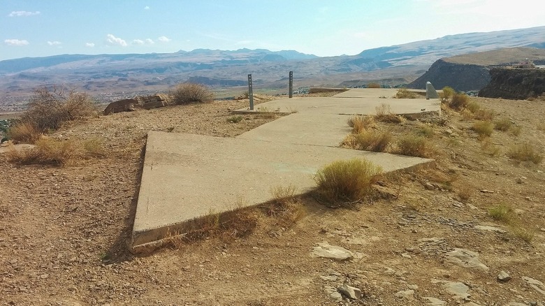 An early airmail navigation arrow atop a ridge
