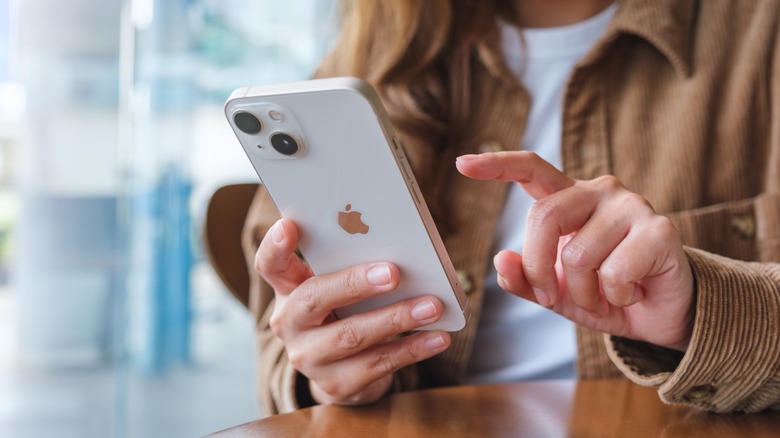 woman typing on iPhone