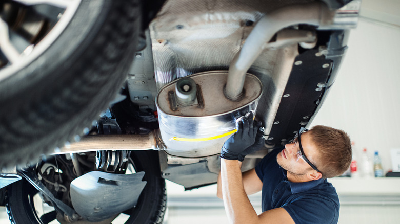 A Service Technician Cleaning Off Exhaust System