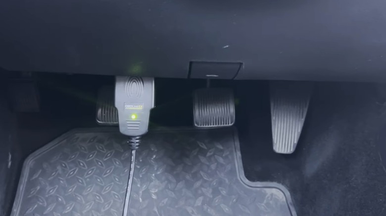 An OBDII tool connected to the OBDII port in a Ram diesel pickup truck