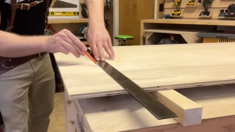 Carpenter marking line on board