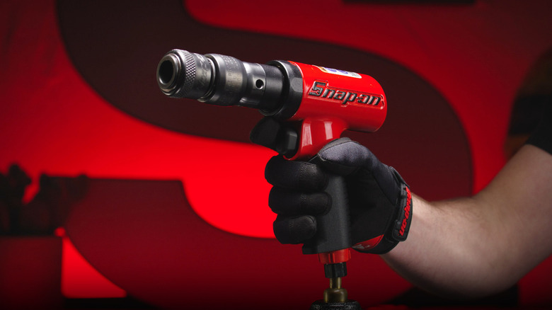 One of Snap-on Tool's PH3045A air hammers held in a gloved hand.