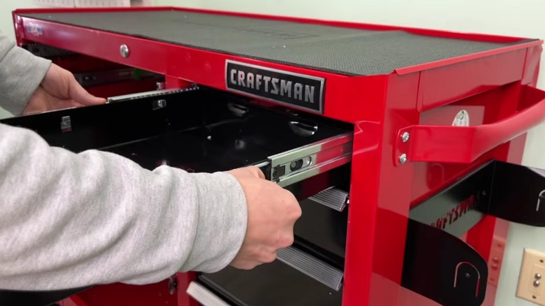 Removing a drawer from a craftsman tool cabinet.