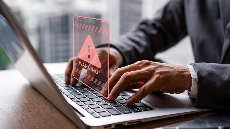 Laptop with warning icon