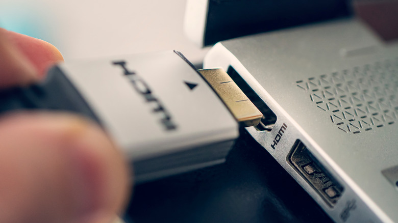 Hand plugging in HDMI