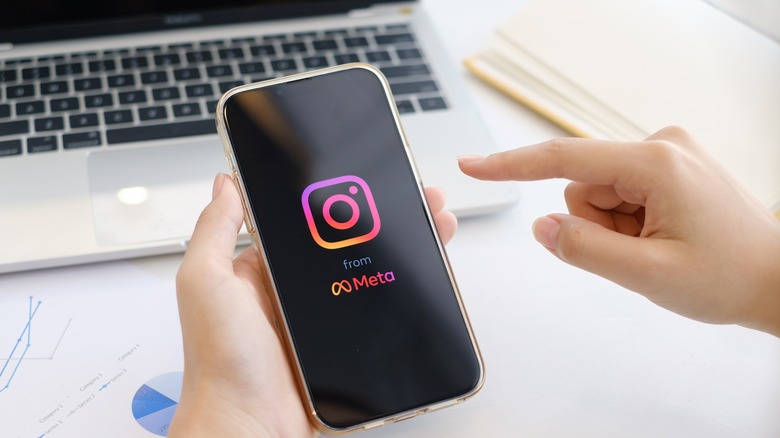 woman checking instagram while working