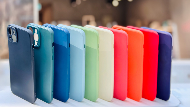 A series of smartphone cases standing on table, blurry background
