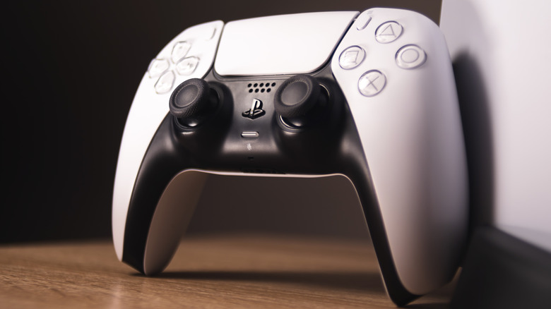 photo of a propped up white PS5 DualSense controller