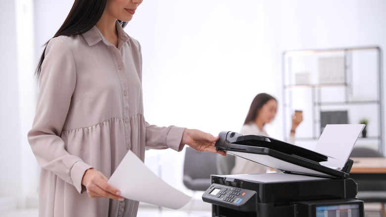 person using scanner in office