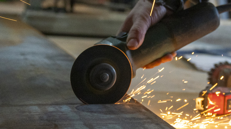 Sparks flying off of a cutting angle grinder.