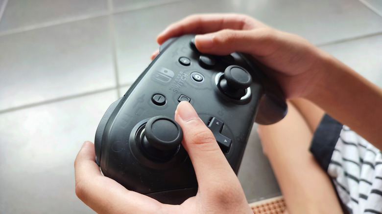 Nintendo switch pro controller in hand