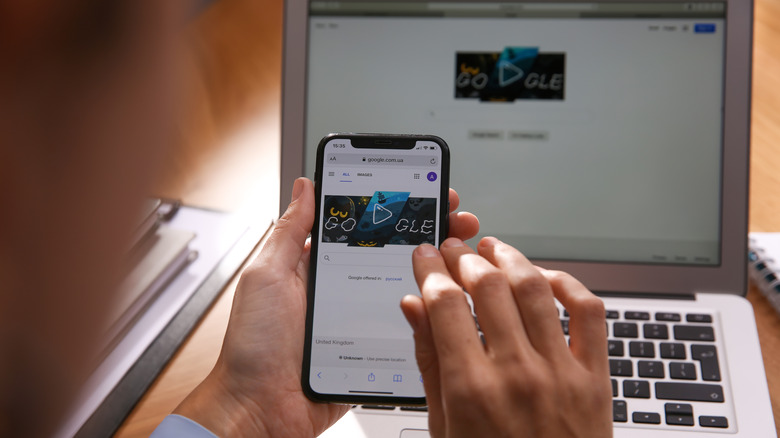 Person using iPhone with Mac