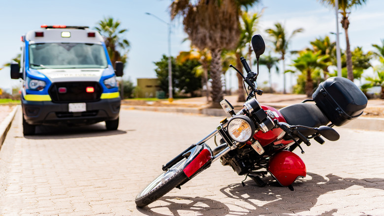 Tipped over motorcycle in front of emergency vehicle
