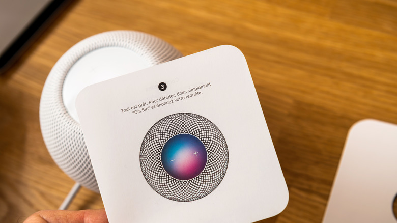 HomePod devices on table with instruction manual