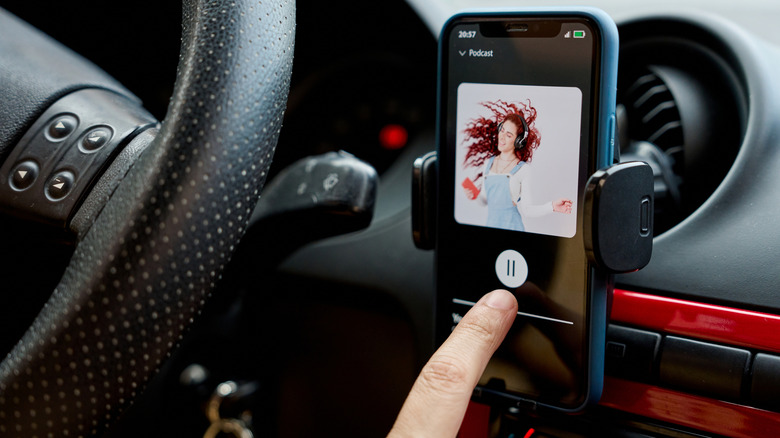 Person choosing to play a podcast from Apple Music