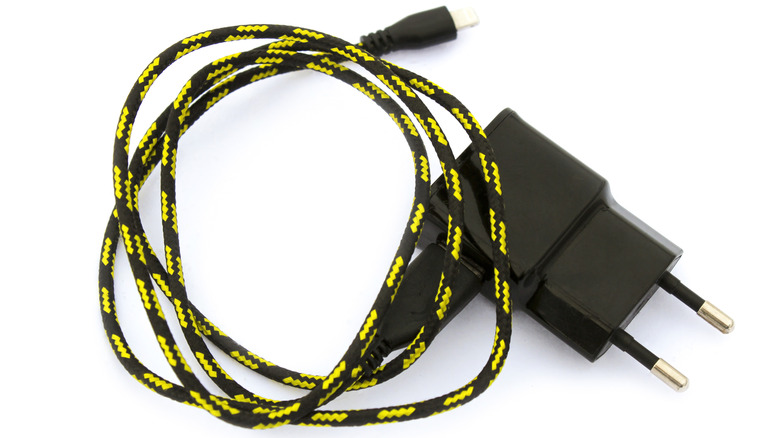 A black and yellow braided cable with power adapter