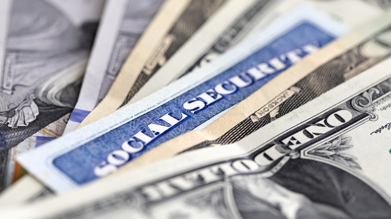 Close-up of Social Security card amongst US currency bills