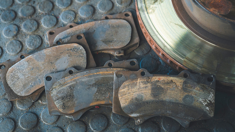 A close-up of worn brake pads that have been removed from a caliper