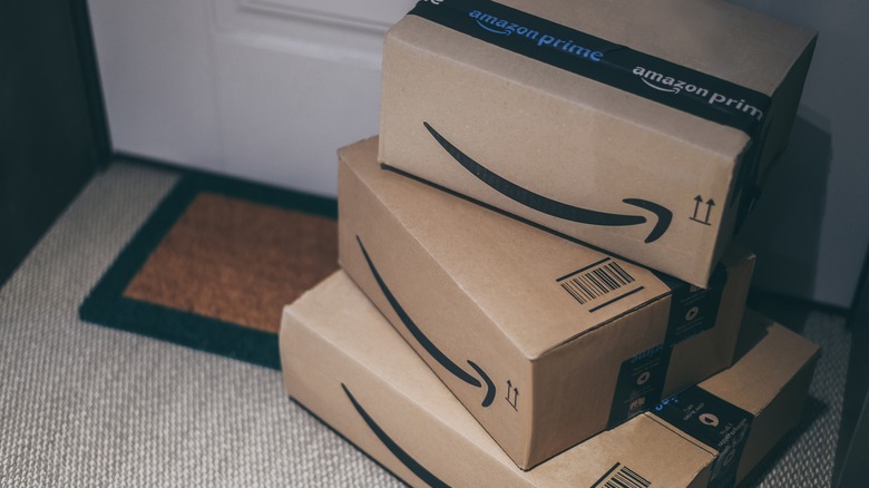 Amazon boxes stacked up at a front door