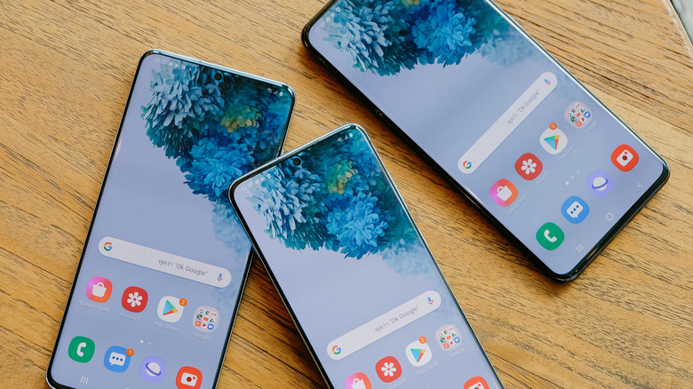 three Samsung phones on table