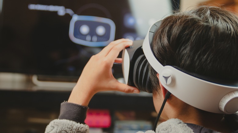 Child adjusting PS VR2 headset