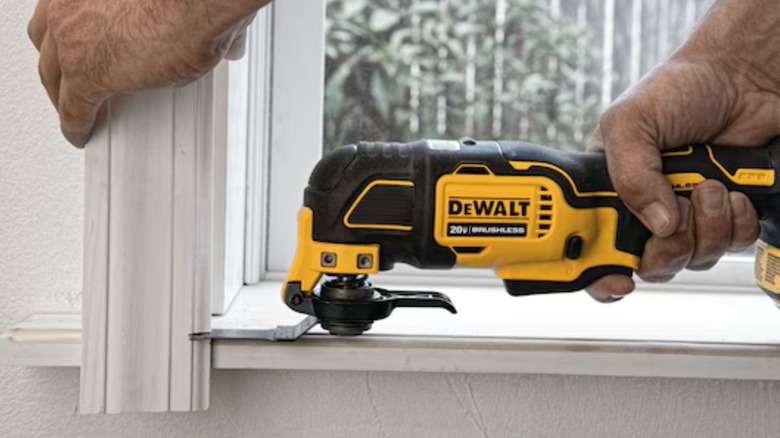 Using the DeWalt 20V MAX* Brushless Oscillating Tool to cut window trim to size.