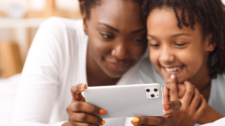 mother and child using iphone