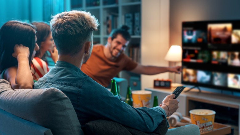 friends watching a movie on a couch