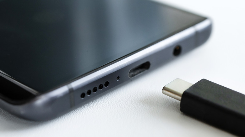 Plugging USB-C cable into a smartphone