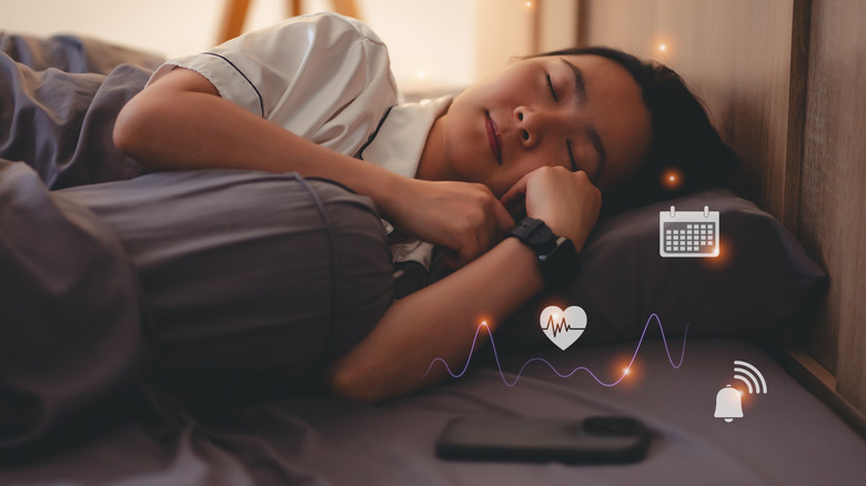Sleeping woman wears smartwatch with sleep tracking
