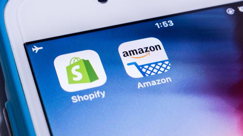 Amazon and Shopify app logos on iPhone home screen