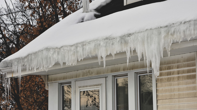 Melting snow on roof creating ice dam in gutter